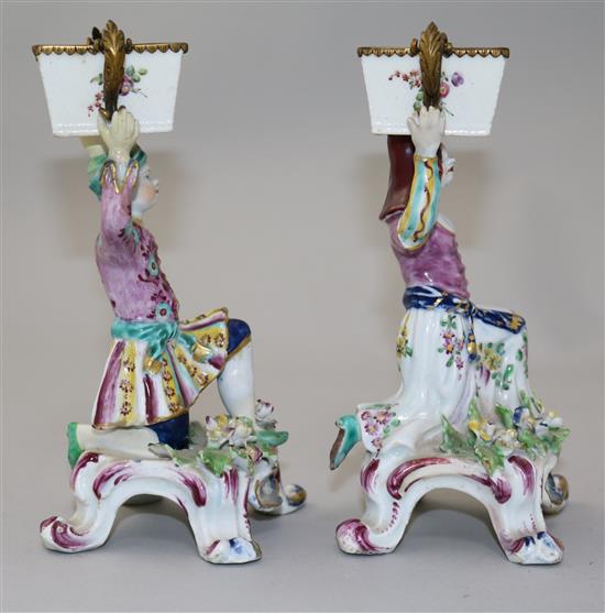 A pair of Bow figural sweetmeat dishes, c.1765-70, height 17cm, restorations